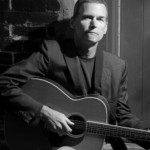 Photo of Neil Bjorklund with guitar